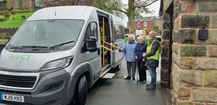 Alan and passengers Minibus driver and 2 passengers standing next to minibus grey in colour.
